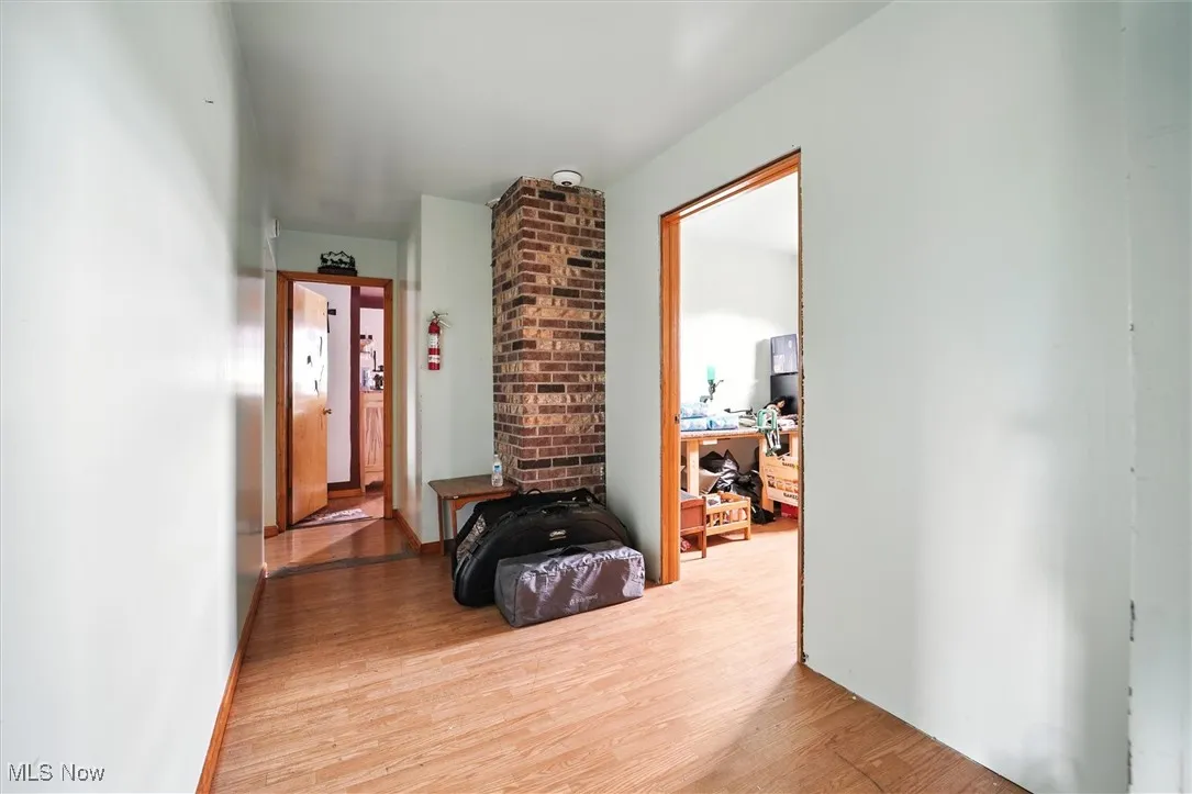 Corridor featuring wood finished floors