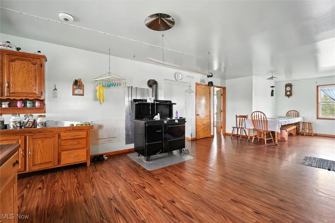 Kitchen featuring brown cabinets and dark wood-style flooring