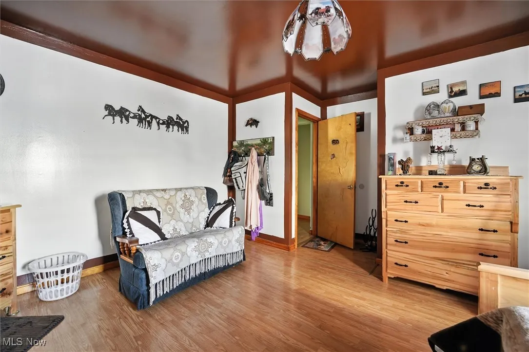 Bedroom featuring light wood finished floors and baseboards