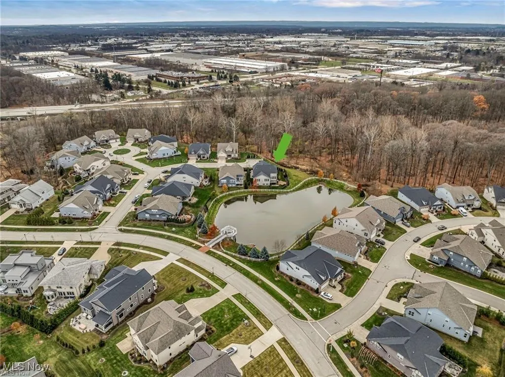 Aerial view of property's location featuring a large body of water and nearby suburban area