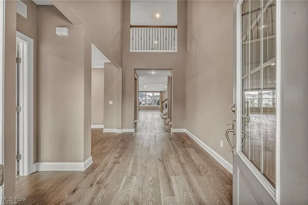 Entrance foyer with light wood-style flooring, a high ceiling, and recessed lighting