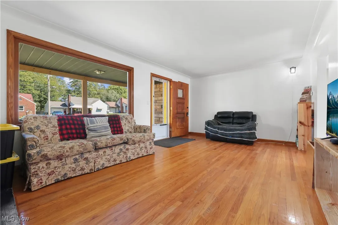 Living area with hardwood / wood-style floors and baseboards