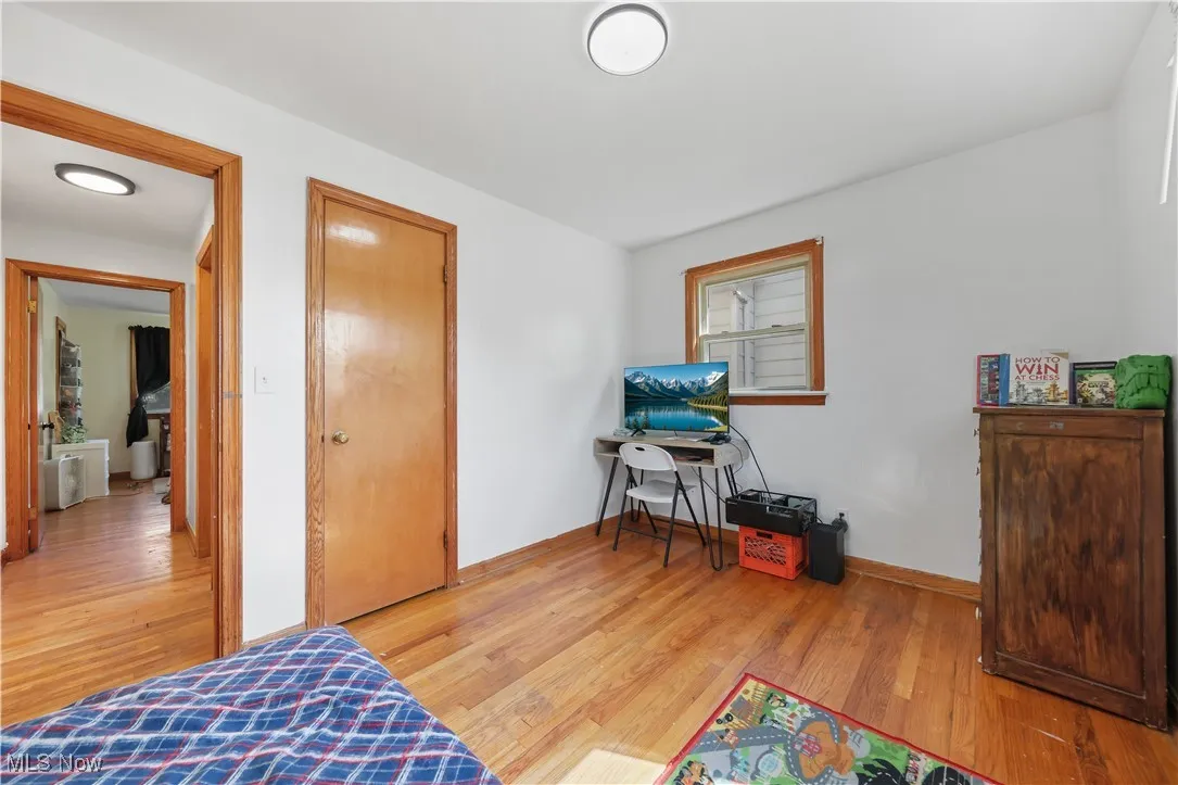 Bedroom with light wood-style floors and a closet