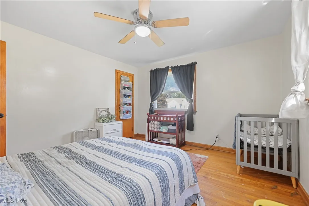 Bedroom featuring wood finished floors and a ceiling fan