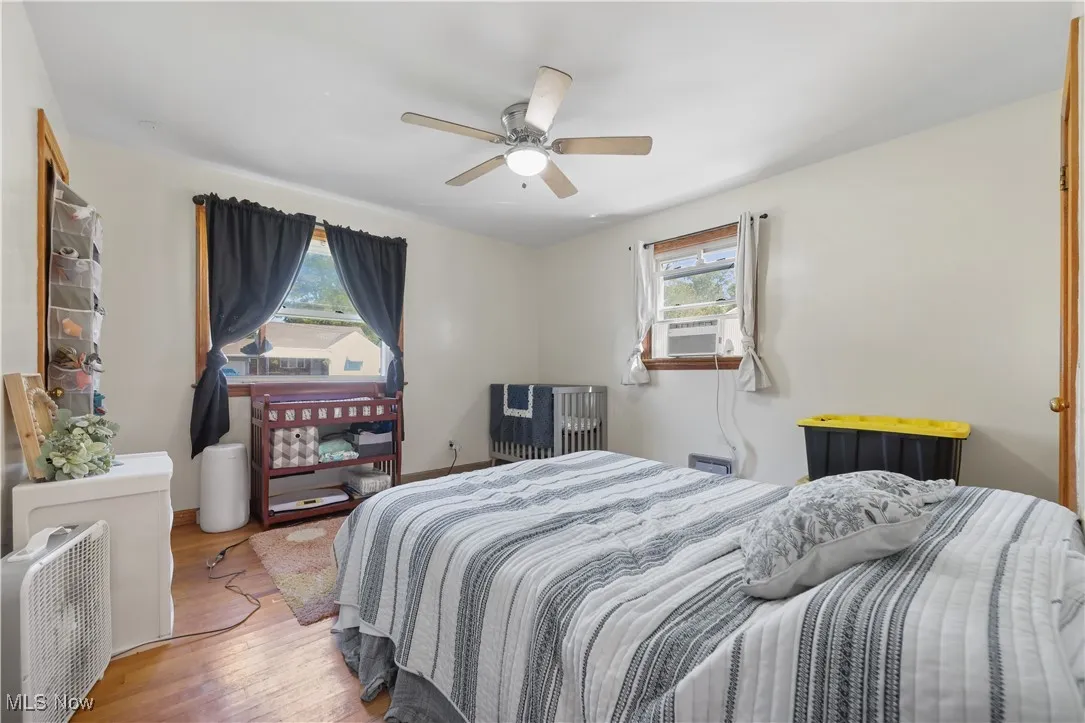 Bedroom with wood finished floors and ceiling fan