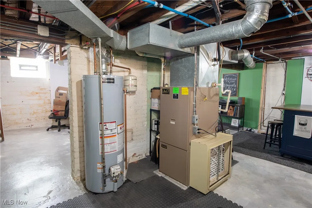 Basement featuring gas water heater and heating unit
