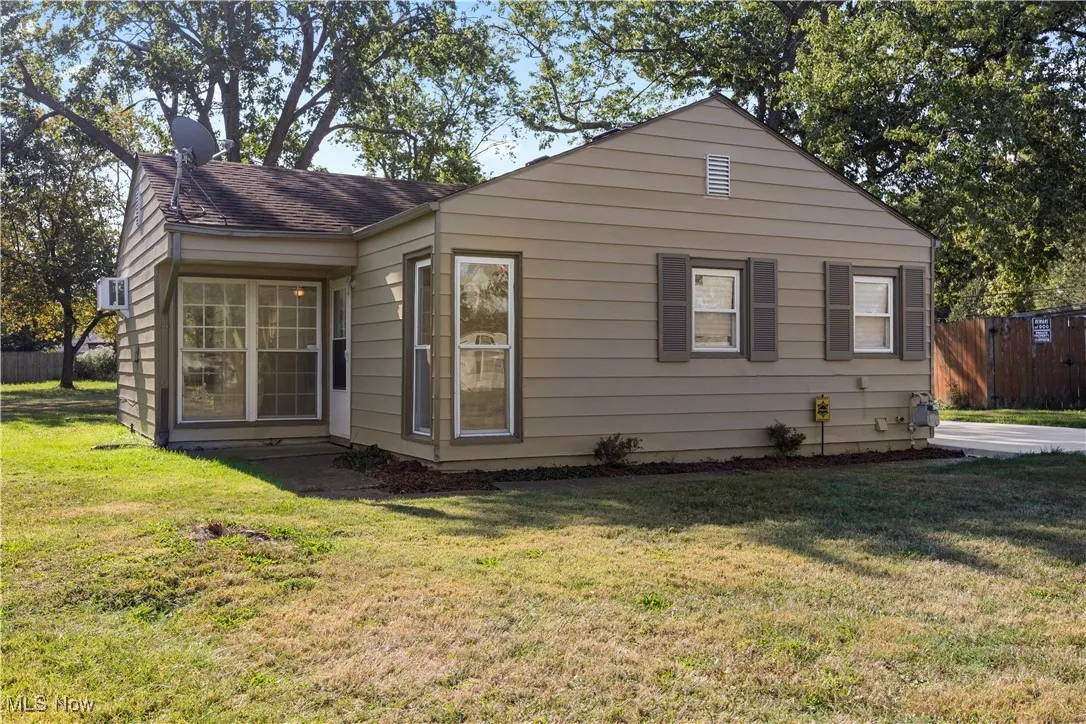 Rear view of house with a shingled roof