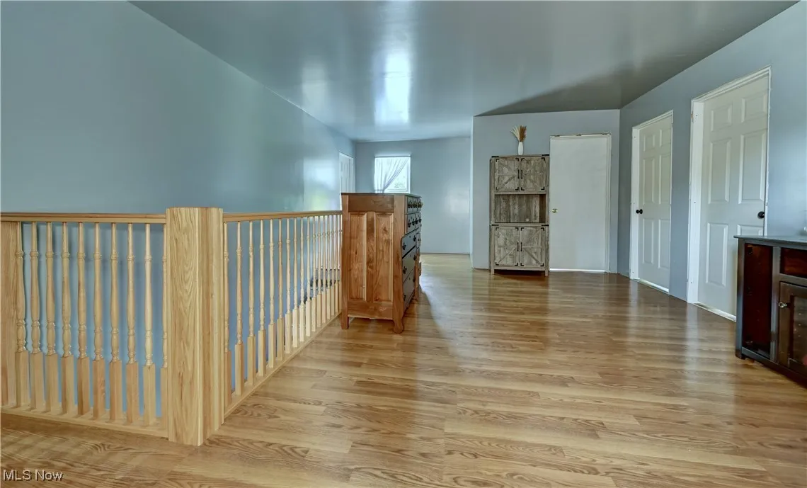 Hallway featuring light wood finished floors