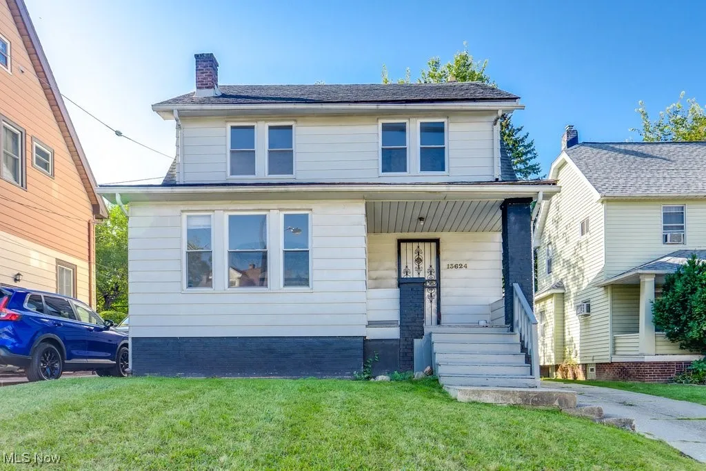 Traditional style home with a chimney and a front lawn