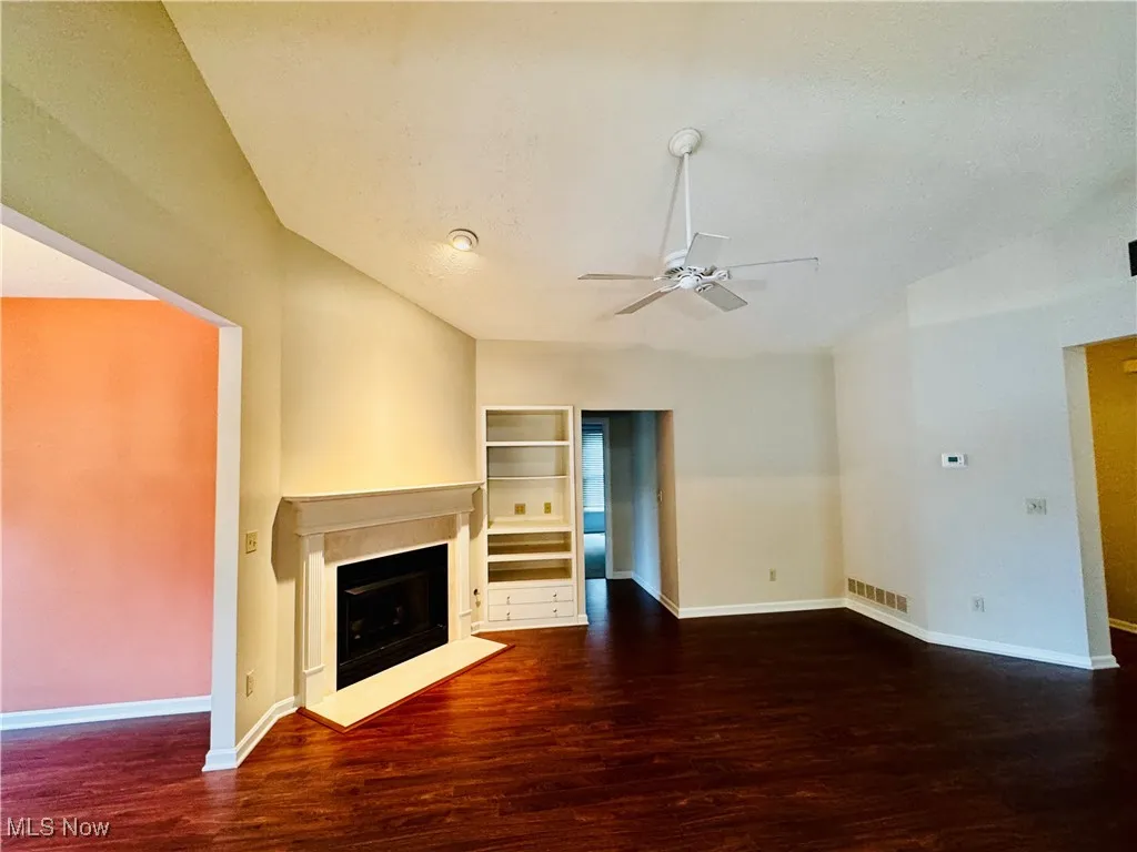 Living room with laminate plank floors and gas fireplace