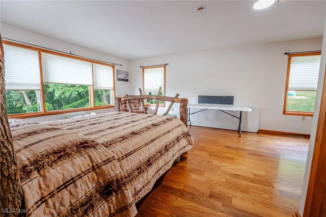 Bedroom with light wood-style flooring and baseboards