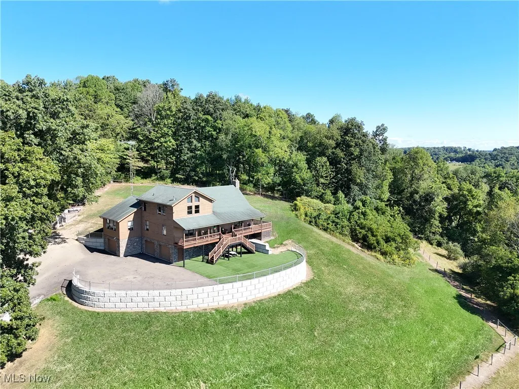 View of subject property with a forest