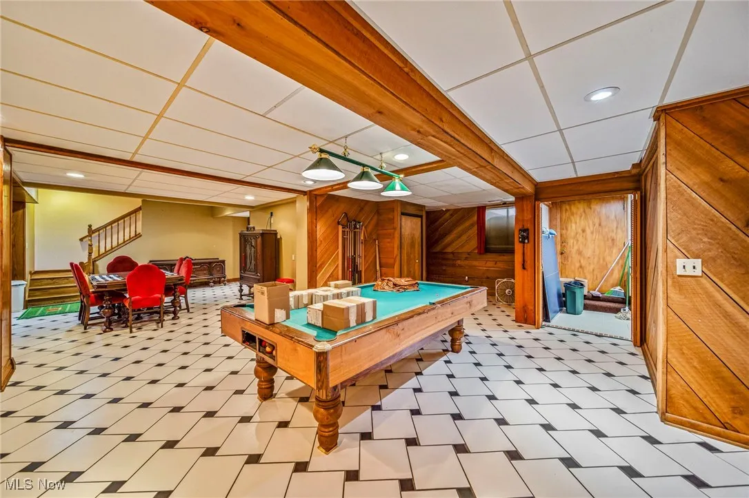 Rec room with a drop ceiling, wood walls, light floors, billiards table, and recessed lighting