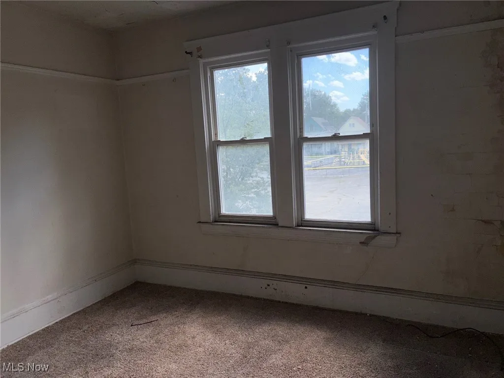 Unfurnished room featuring carpet flooring