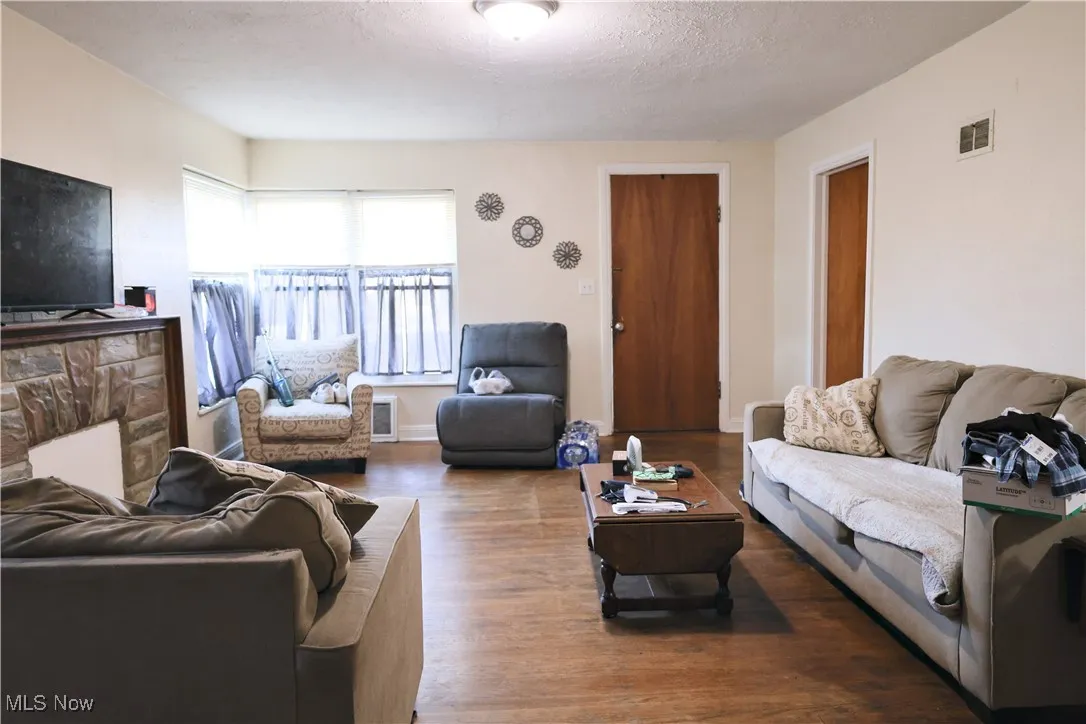 Living area featuring wood finished floors and a textured ceiling