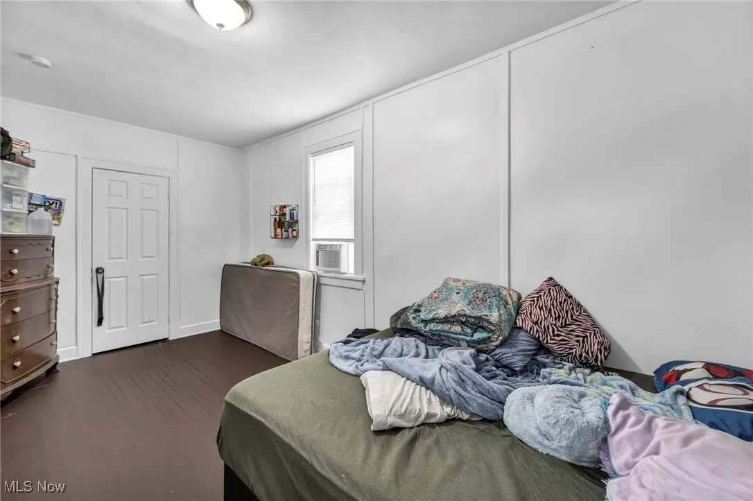 Bedroom with dark wood-style floors