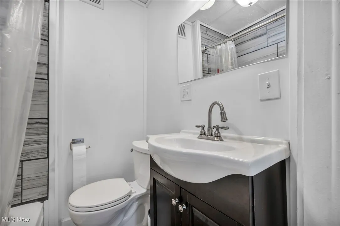 Full bath featuring toilet and vanity
