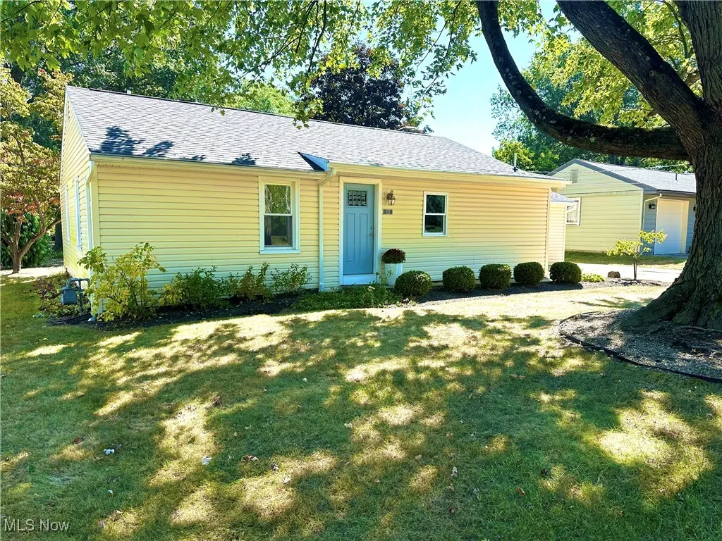 Single story home with roof with shingles and a front lawn