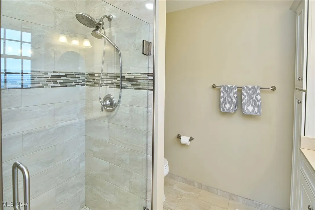 Full bath with a stall shower and vanity