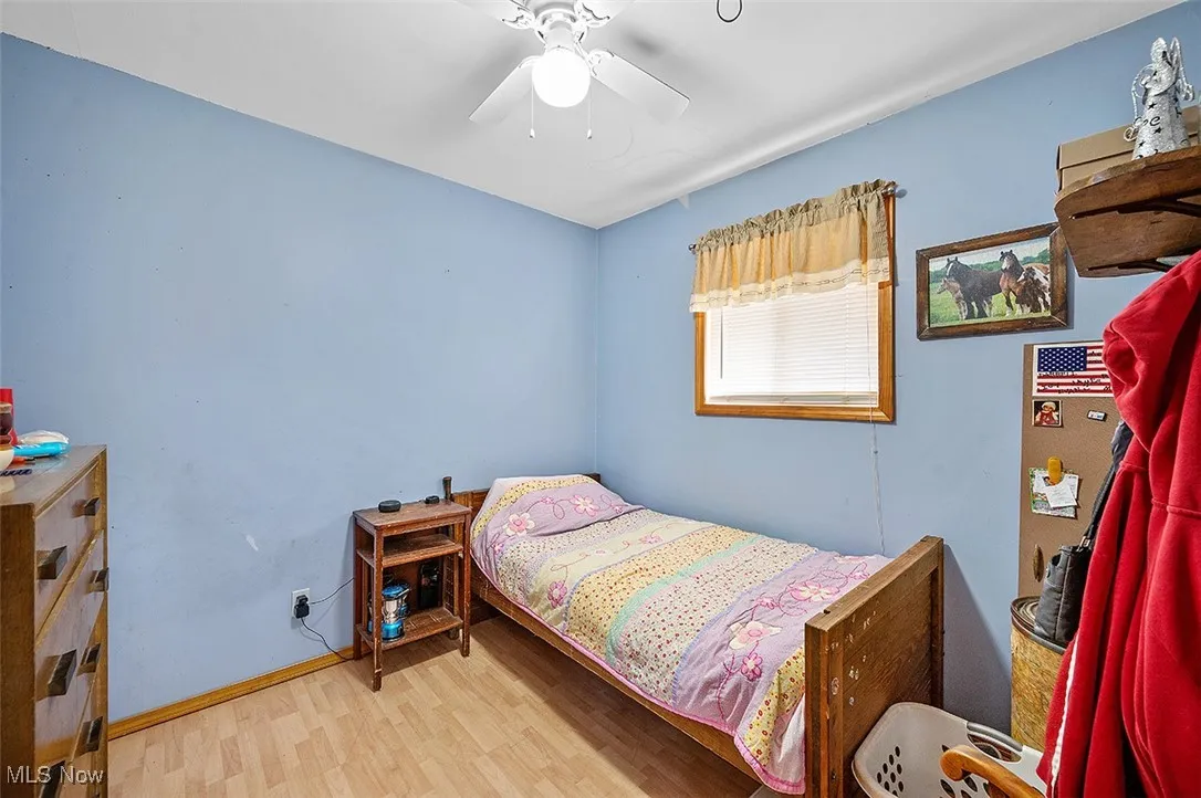 Bedroom featuring wood finished floors and a ceiling fan