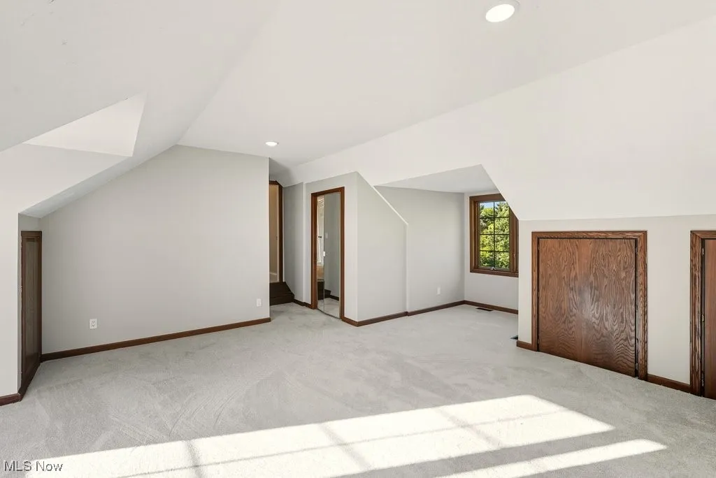 Bonus room featuring lofted ceiling, carpet floors, and recessed lighting