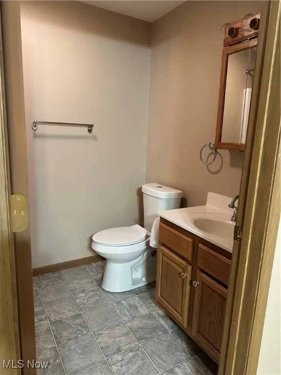 Bathroom featuring vanity and light stone finish flooring