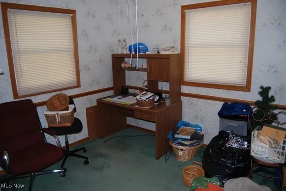 Carpeted office with wallpapered walls