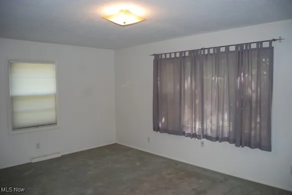Spare room featuring baseboards