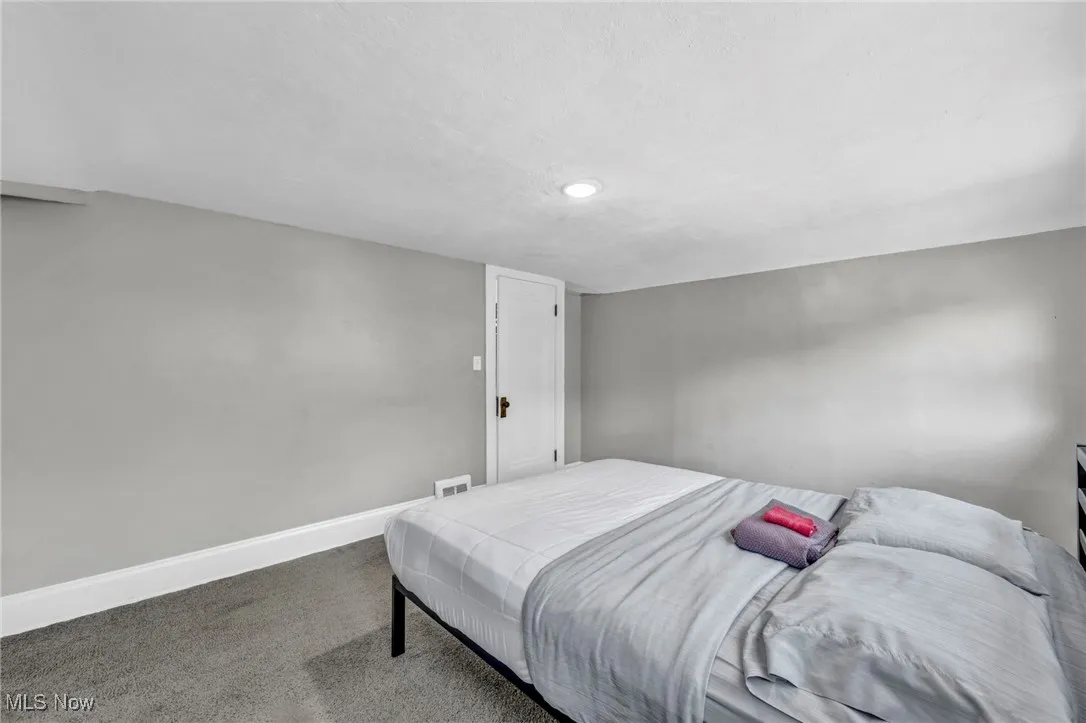 Bedroom featuring carpet and a textured ceiling