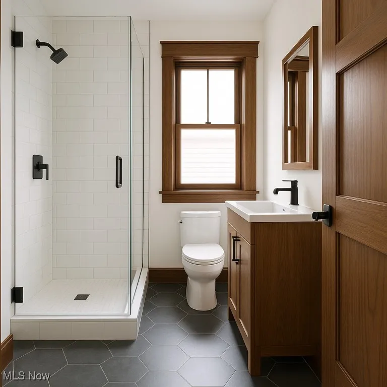 VIRTUALLY UPDATED Full bathroom with vanity, dark tile patterned flooring, and a stall shower