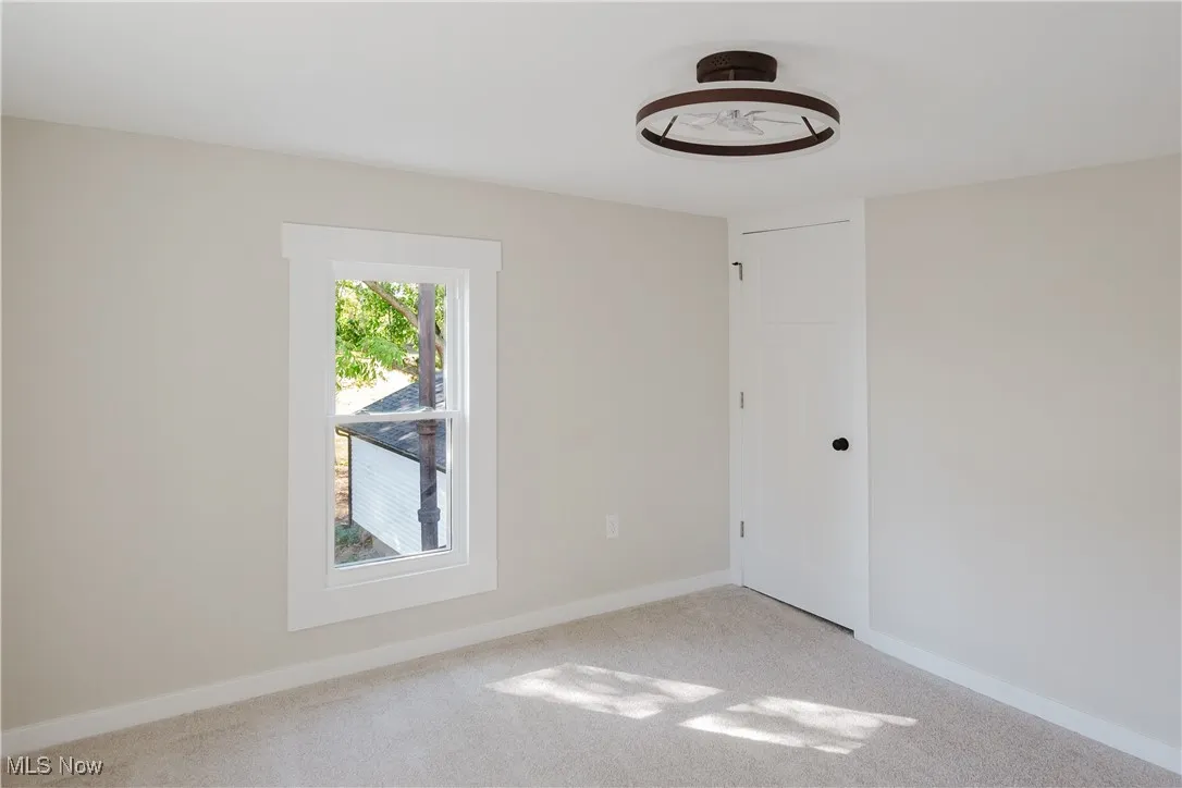 Bedroom with carpet flooring and baseboards