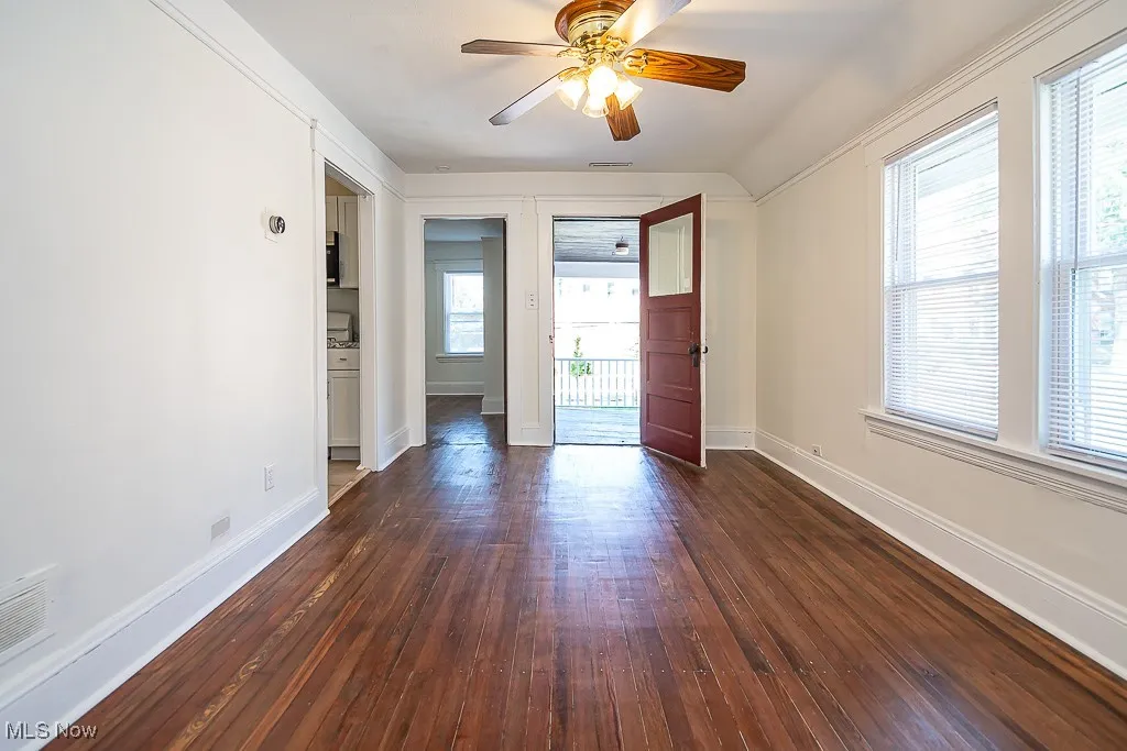 Unfurnished room featuring dark wood finished floors and a ceiling​​‌​​​​‌​​‌‌​‌‌​​​‌‌​‌​‌​‌​​​‌​​ fan