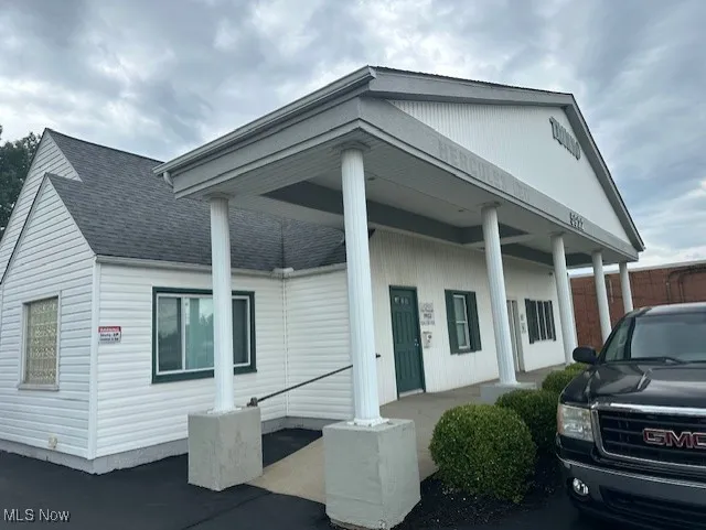 View of front of house with roof with shingles and a porch
