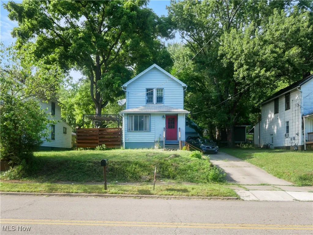 View of front of property with a front lawn and entry steps