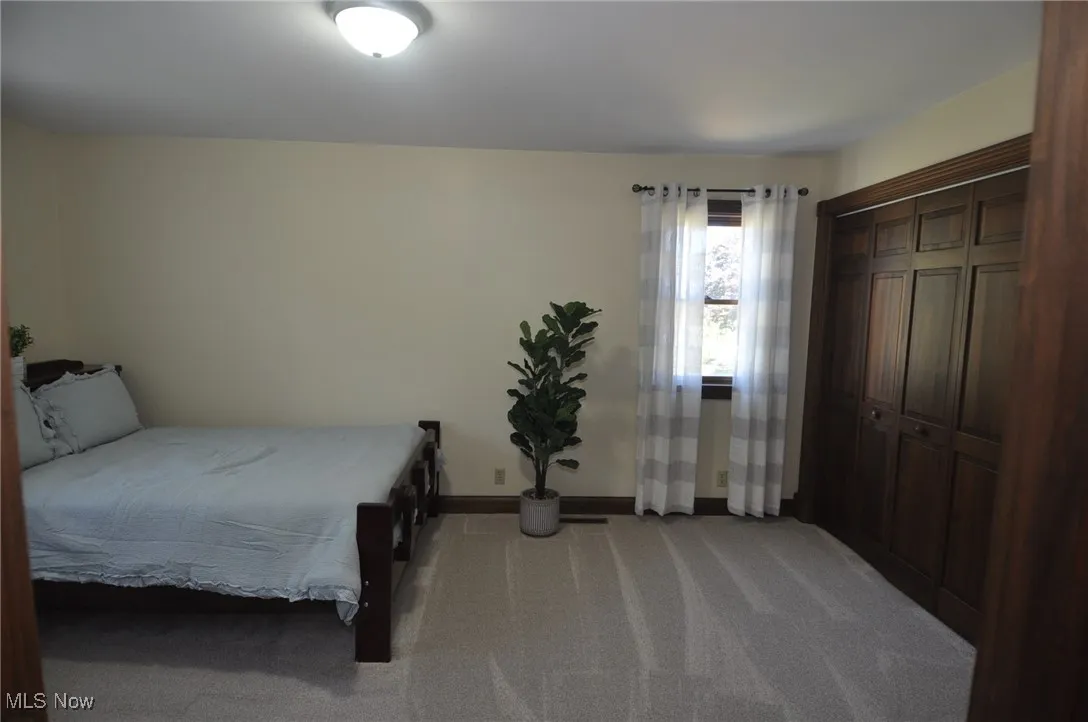 3rd Bedroom with a closet and light colored carpet