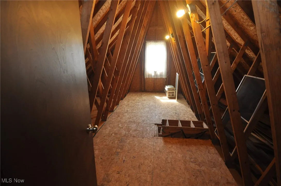 View of unfinished attic/storage off 2nd bedroom