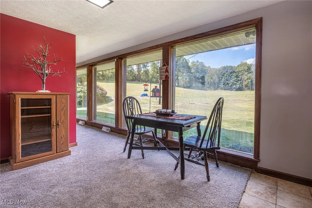 Dining room with baseboards and a textured ceiling