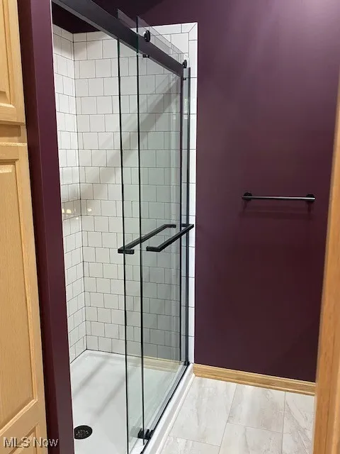 Bathroom featuring a shower stall off of the family room