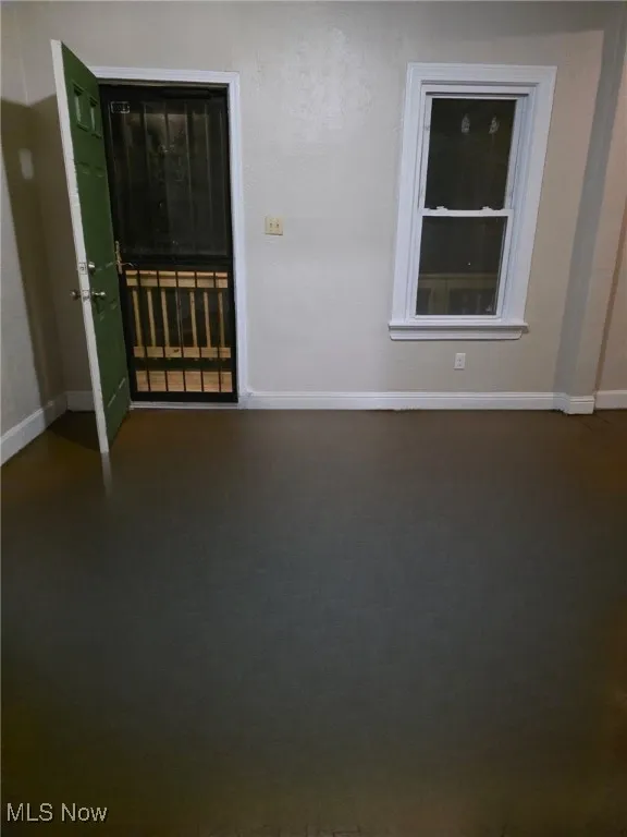 Unfurnished room featuring baseboards