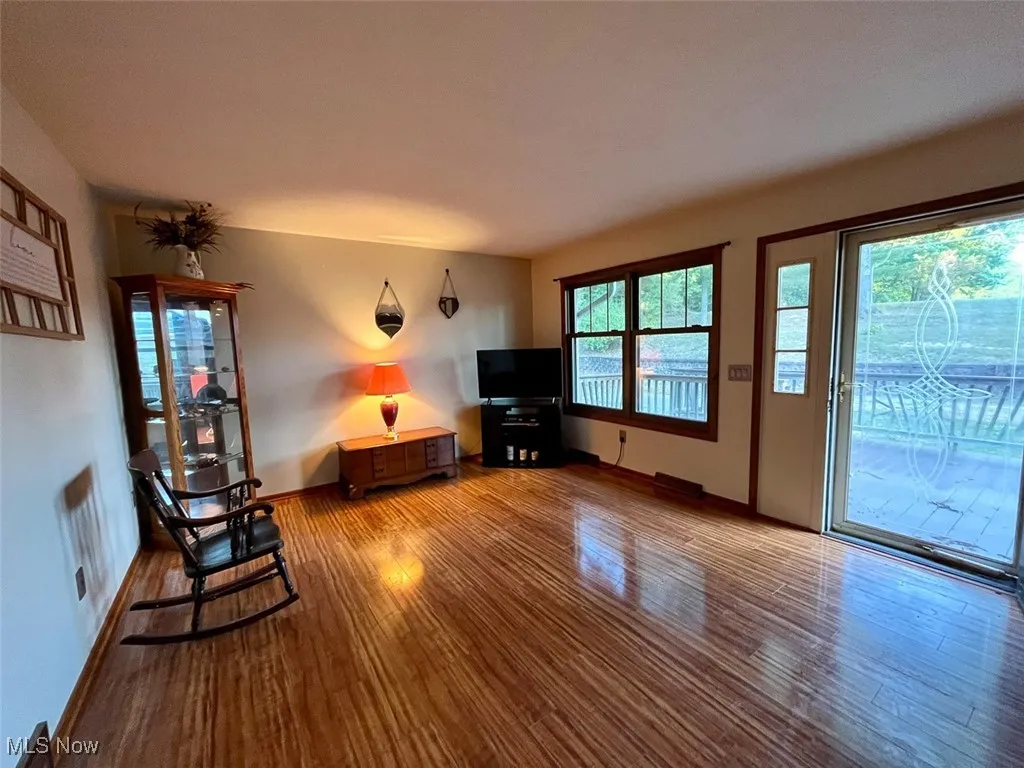 Living area with wood finished floors and baseboards
