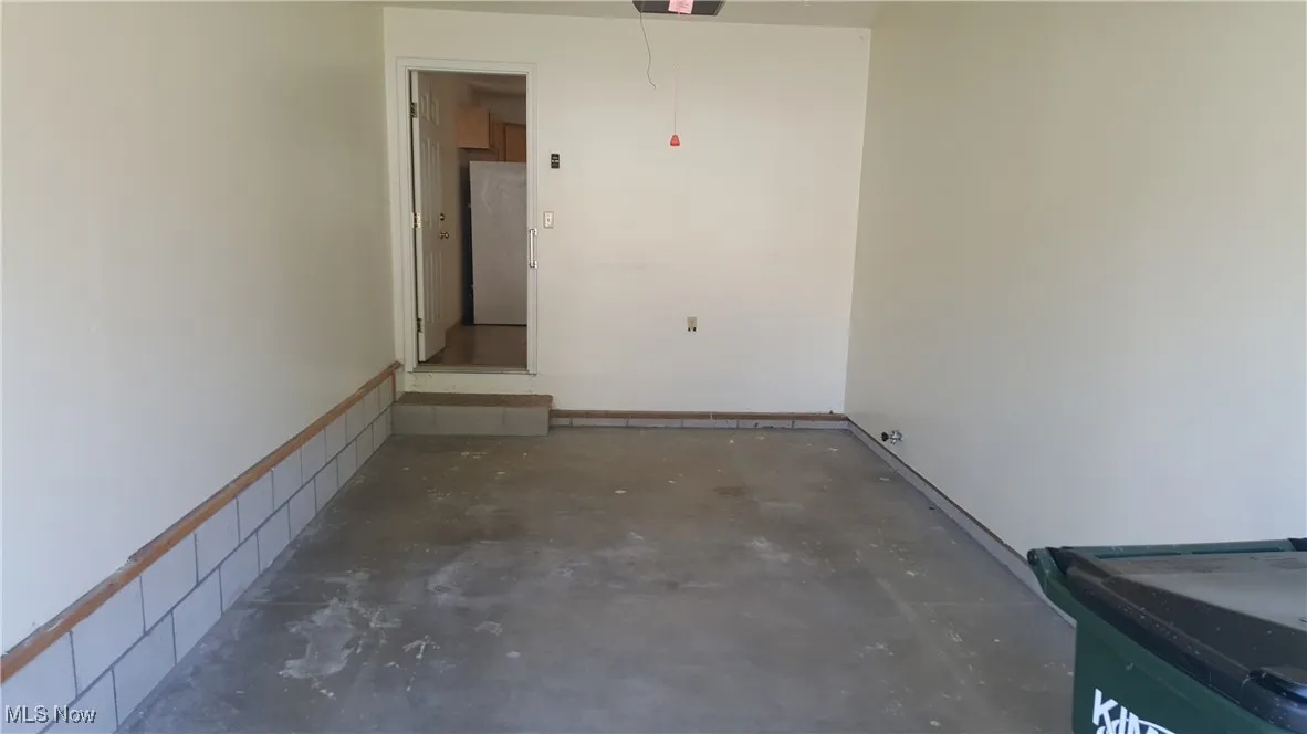 Garage featuring freestanding refrigerator
