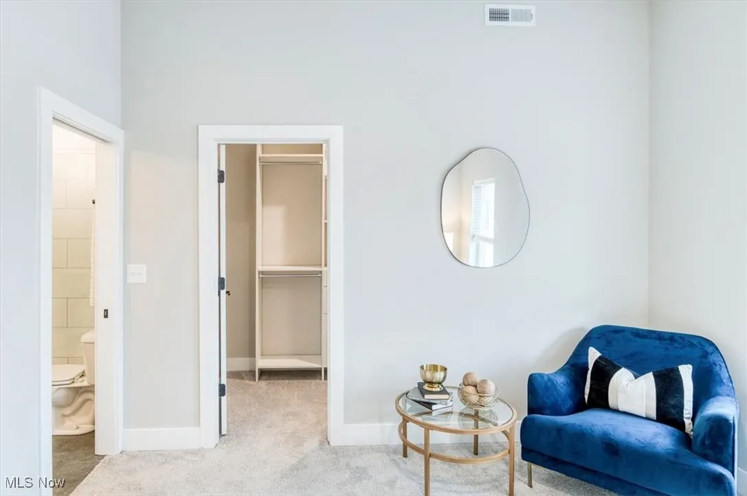 Living area with carpet floors and baseboards