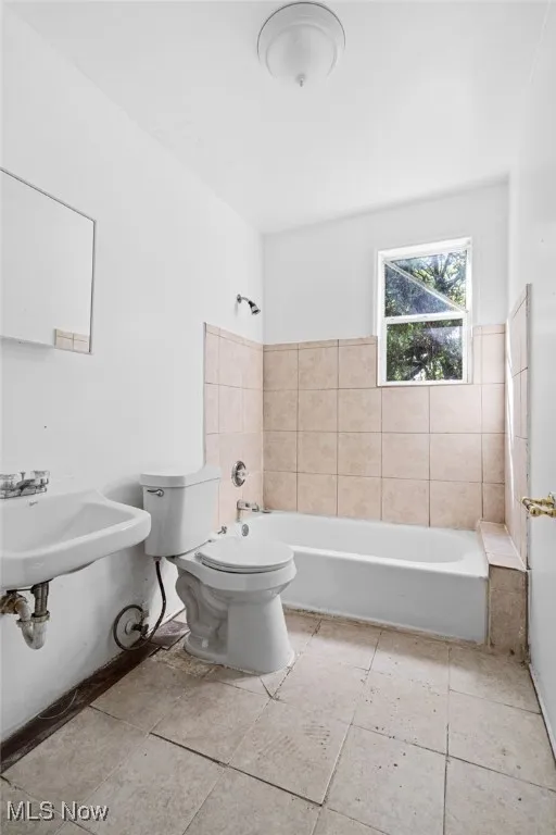 Bathroom with shower / bathtub combination and light tile patterned floors