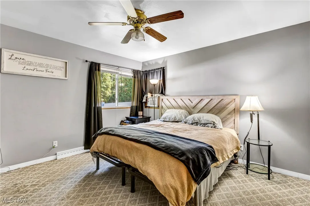 Bedroom featuring light colored carpet and a ceiling fan