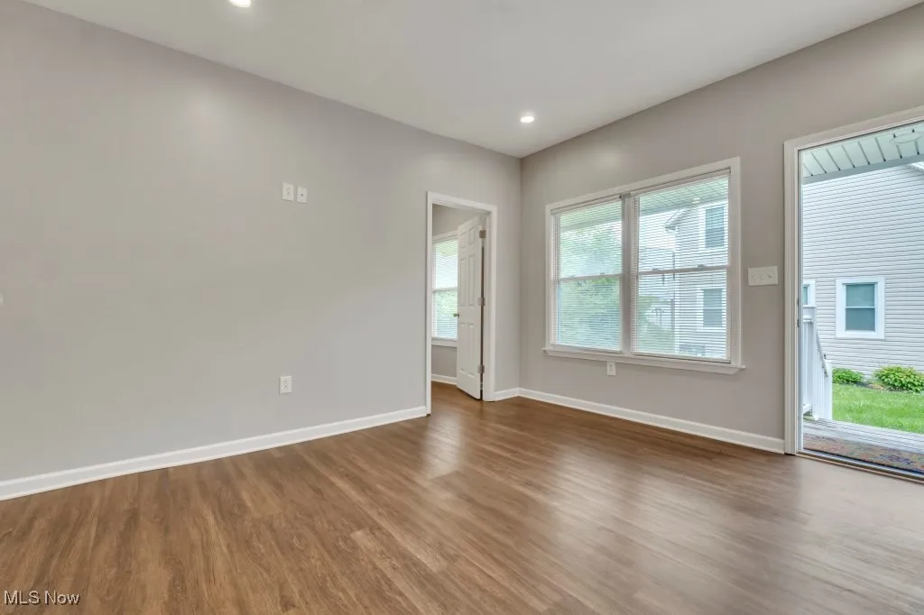 Empty room featuring dark wood-style floors and recessed lighting