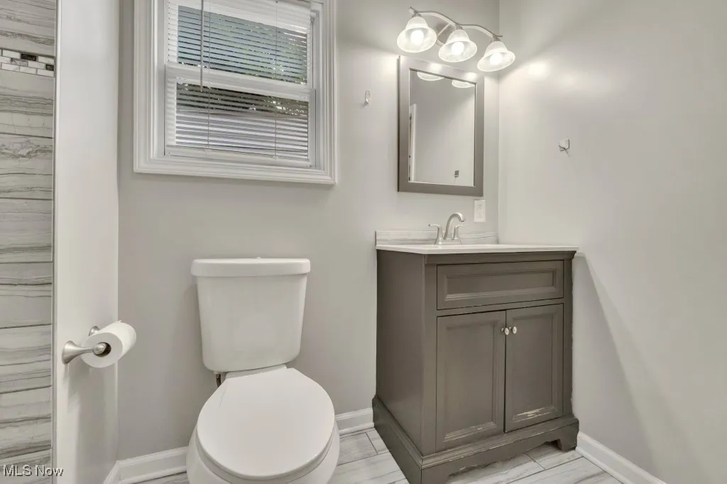 Bathroom featuring baseboards and vanity