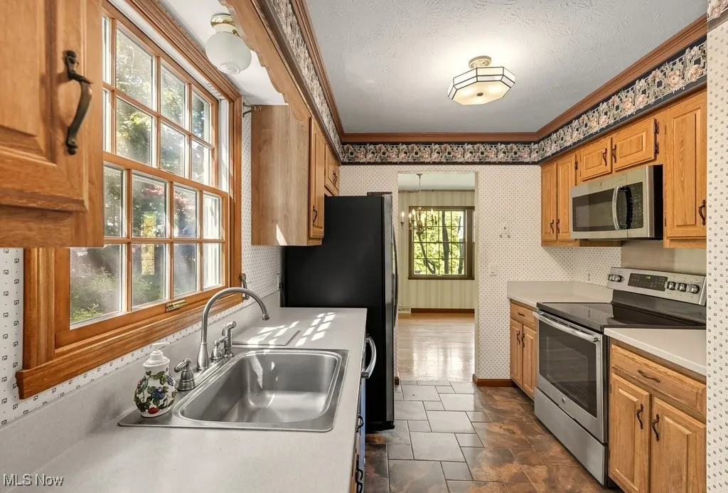 Kitchen with Refaced Cabinets, Microwave Disposal, and Dishwasher