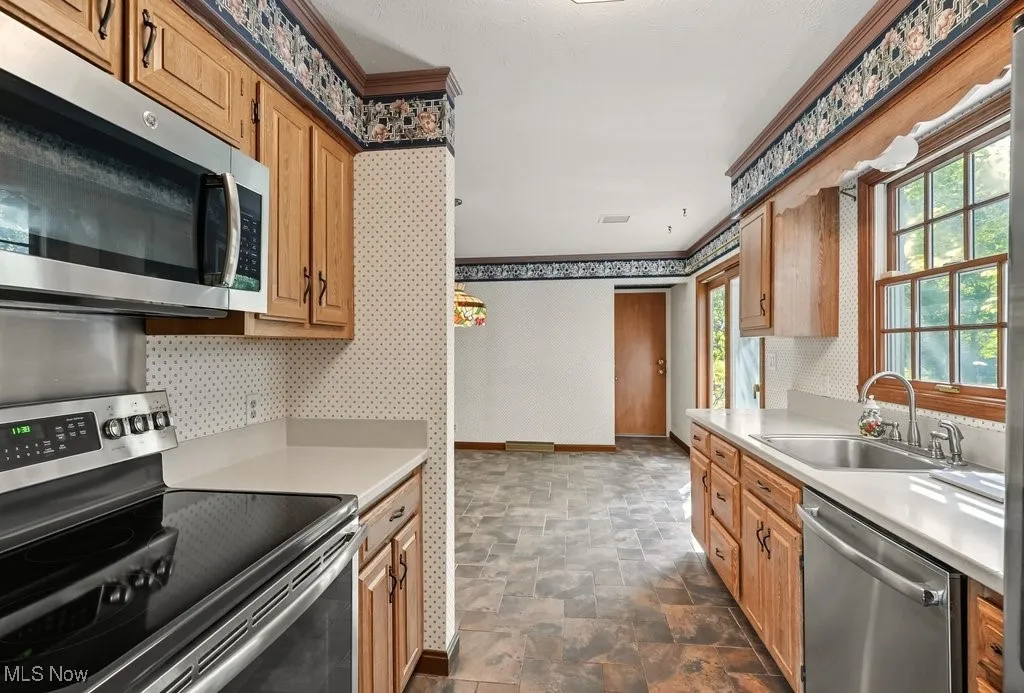 Kitchen with Refaced Cabinets, Microwave Disposal, and Dishwasher