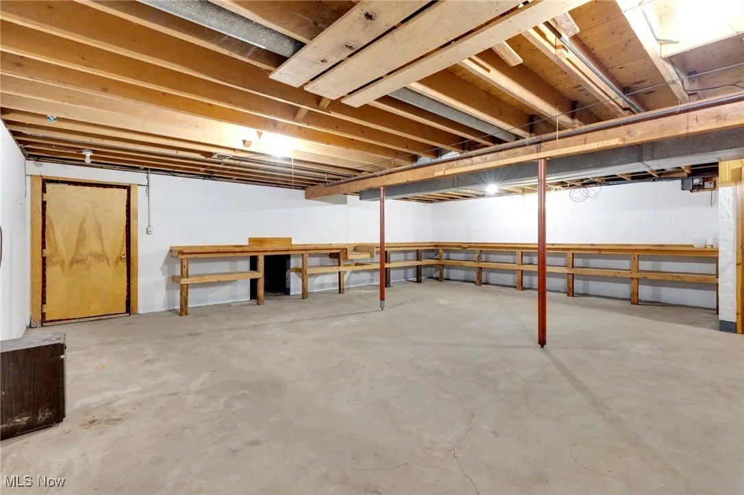 Storage all around with a door leading to stairs into the garage.