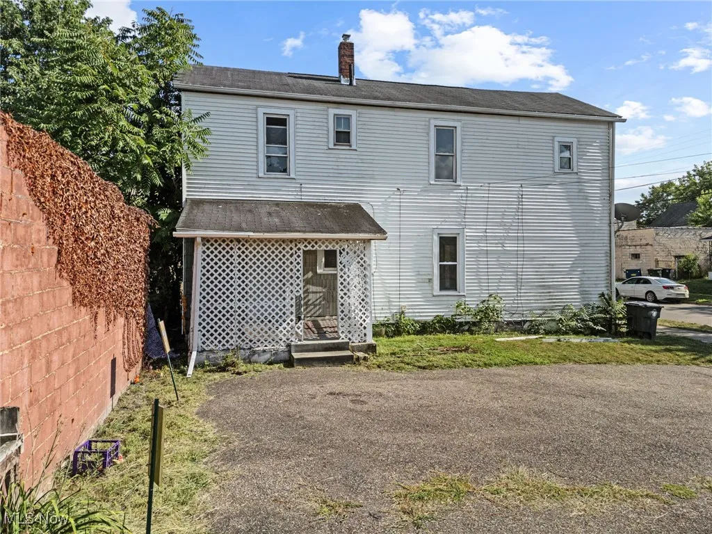 Back of property with a chimney